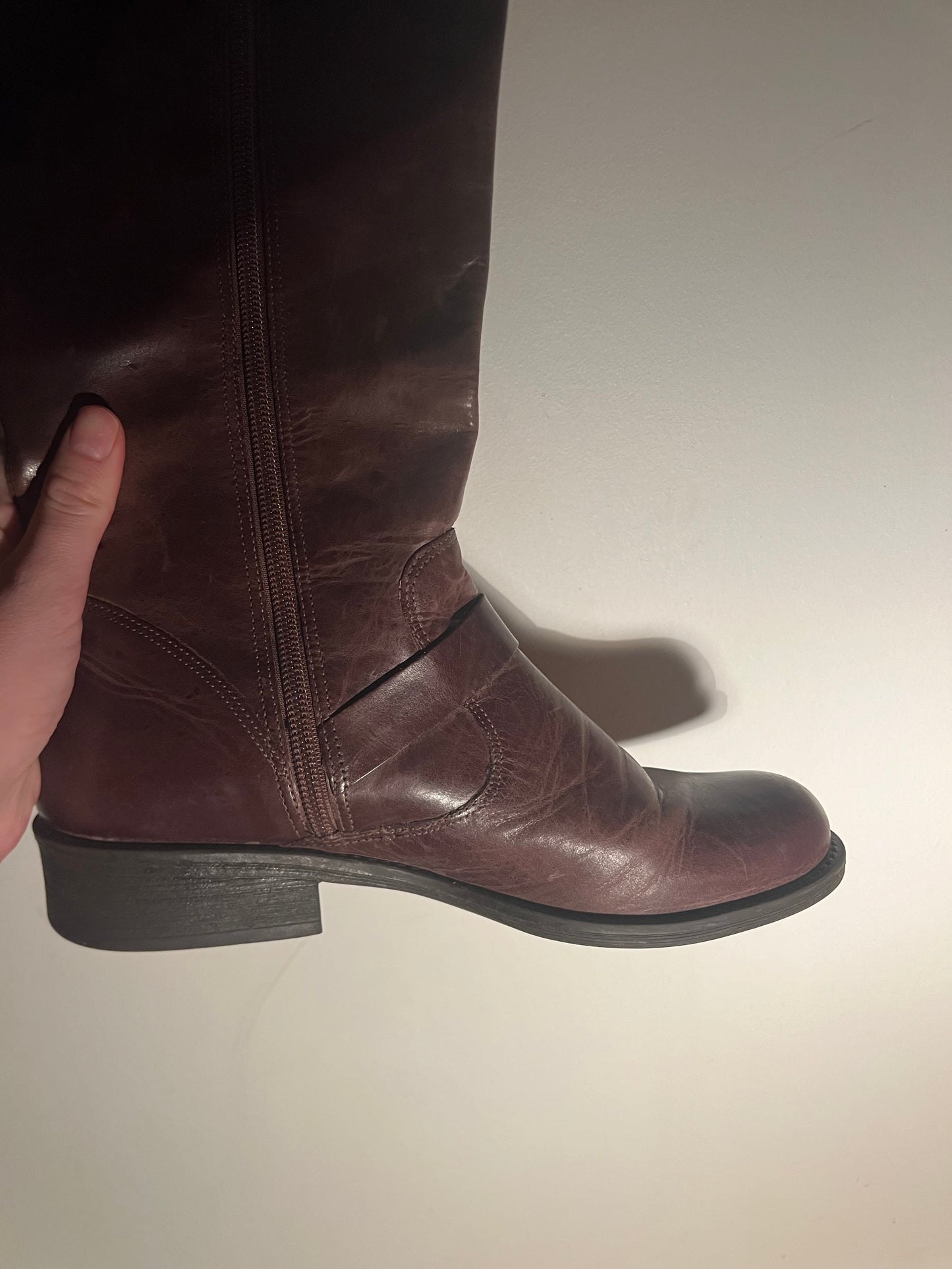 Brown leather boots with metal buckles